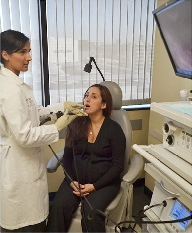 Figure 3: Modern stroboscopy examination performed through the mouth with a high definition camera and display.